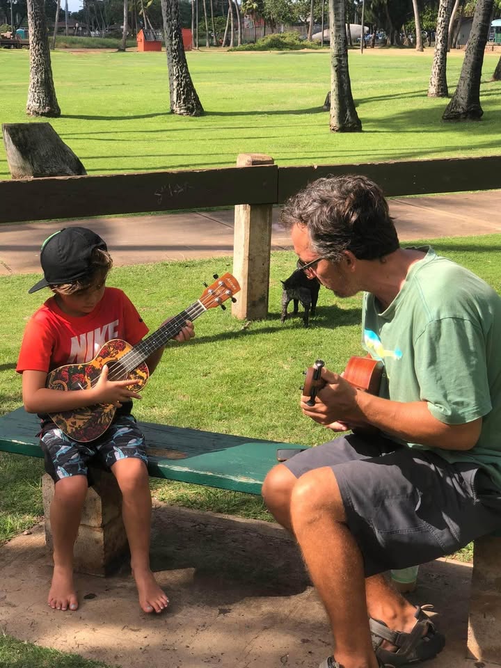 Close-up of hands playing acoustic guitar during private lesson